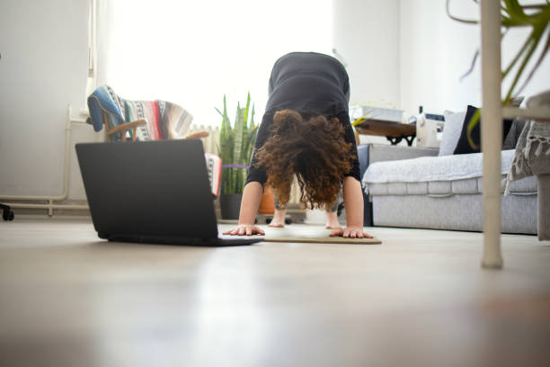 istock Young woman practicing yoga at home 1223640537