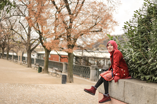 asian hijab traveler enjoy autumn season beside the Vltava river, in Prague