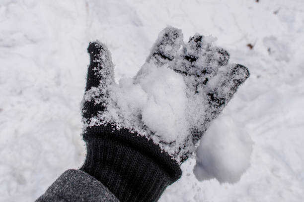 istock playing with snow in hand, Winter landscape 1223642313