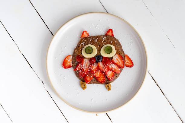 istock Creative owl pancake for kids in a plate isolated on white background 1223647787