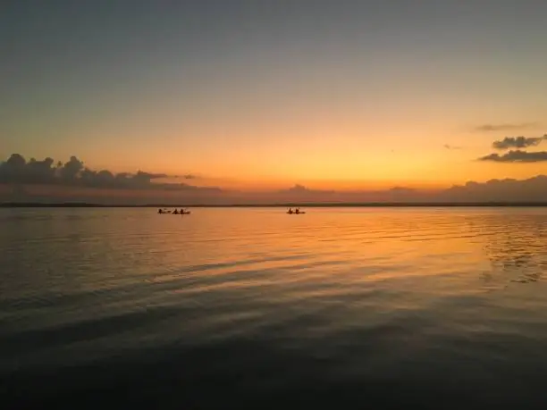 Photo of Beautiful ocean view with clean water, evening, night. Amazing background of island, Caribbean, Lagoon Bacalar. Calm secluded place without people, paradise. Sunset or sunrise