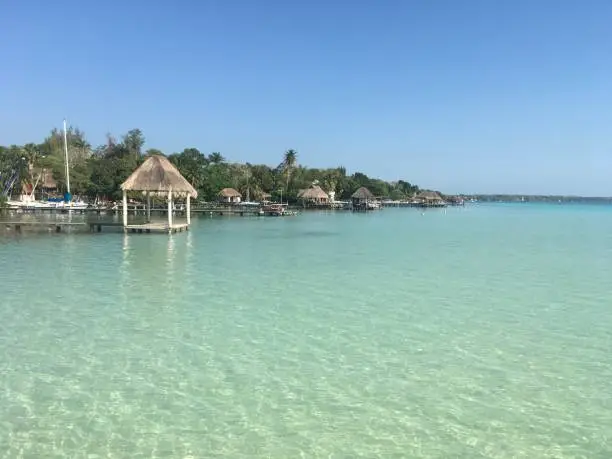 Photo of Beautiful ocean view with clean blue turquoise water, sunny day. Amazing background of island, Caribbean, Lagoon Bacalar. Calm secluded place without people, paradise