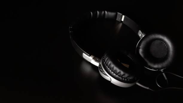 istock Black headphones isolated on a black background,close up. 1223649134