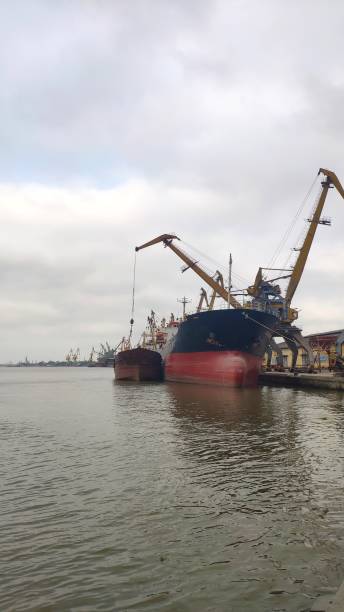 istock Aerial view of business port with shore crane loading container in container ship in import/export and business logistics with crane and shipping cargo.International transportation and business concept. 1223650153
