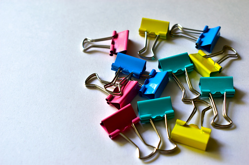 Metal multi-colored stationery paper clips in a group