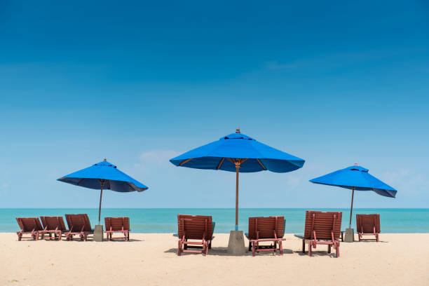 istock Beach bench under the umbrella on tropical island beach 1223650589