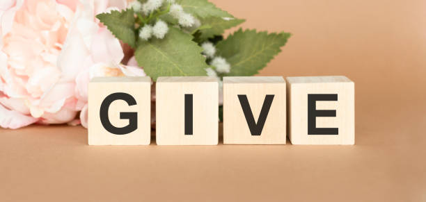 istock GIVE text on wooden cubes on a monochrome background 1223655647