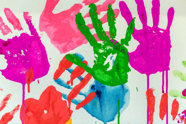 istock Colorful painted hand prints on white background 1223657529