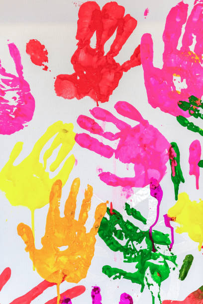 istock Colorful painted hand prints on white background 1223657544