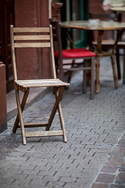 abandoned chairs and tables in front of a restaurant