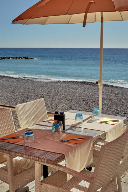 istock A small cozy table in the sun next to the calm sea 1223660948