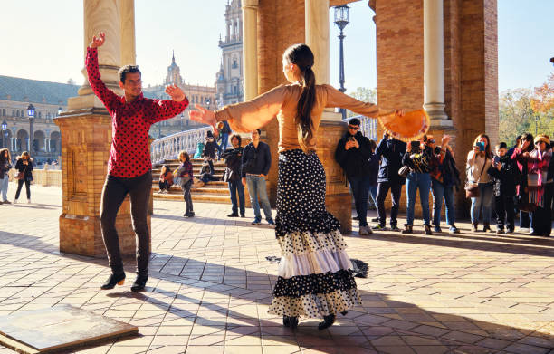 Tourists enjoy street flamenco dance show. Seville, Spain Seville, Spain: December 23, 2019: Tourists enjoy street flamenco traditional show, performance for visitors at Plaza de Espana. Travel attraction and fun, Spanish culture art concept image flamenco photos stock pictures, royalty-free photos & images