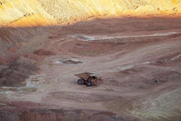 istock A large dump truck surrounded by dirt, background lit by sunset 1223662084