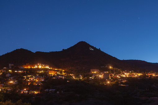 A pulled back view of Jerome Arizona mining town at night lights in Jerome, AZ, United States