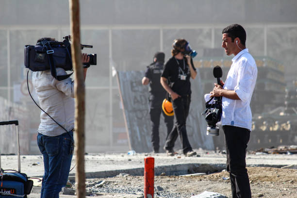 istanbul, taksim / turkey - 06.11.2013: during the gezi park protests, a reporter is doing announcement to his cameraman for the news tv channel. - protest turkey istanbul europe imagens e fotografias de stock