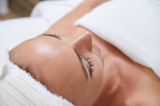 istock Close up on young female face in spa environment ready for treatment 1223667599