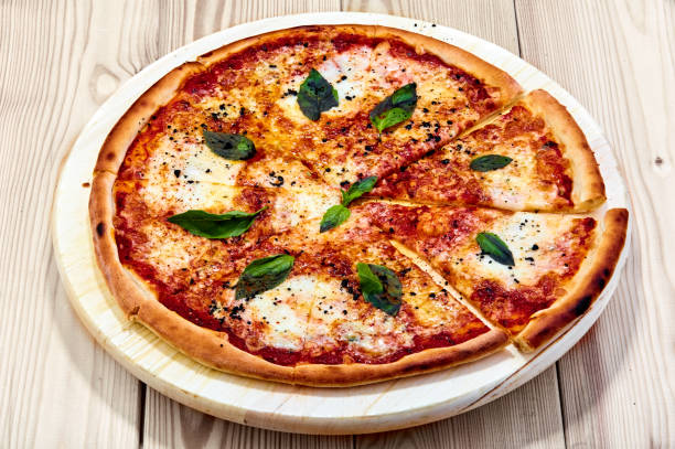 A pizza Quattro Formaggio sitting on top of a wooden table