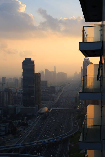 Stunning sunset in Dubai, United Arab Emirates, Dec 2019. Photographed from a hotel balcony towards the Media City area of Dubai. Mesmerizing yellow and orange tones with silhouettes of skyscrapers.