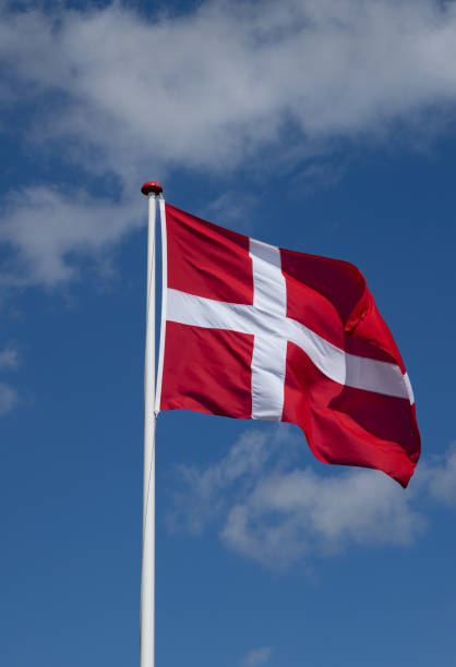 istock danish flag waving in the wind with blue sky and clouds 1223671492