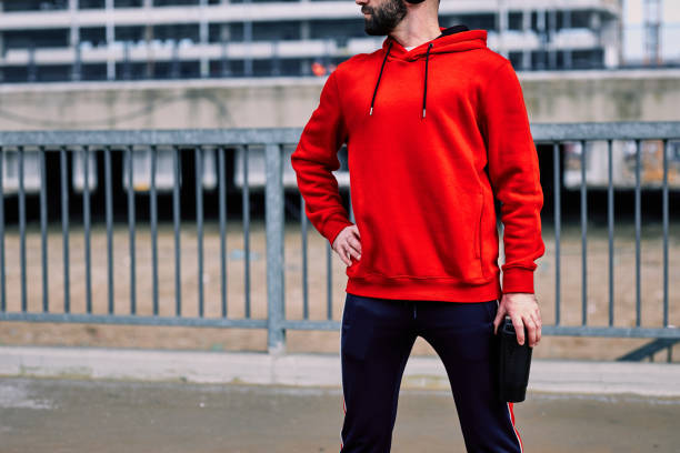 istock Young bearded caucasian sportsman holding bottle with refreshment and taking a break from running. City life concept. 1223672976