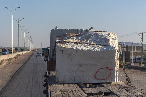 Isfahan, Iran - November 09, 2019. The truck carries a large block of white marble from the quarry.