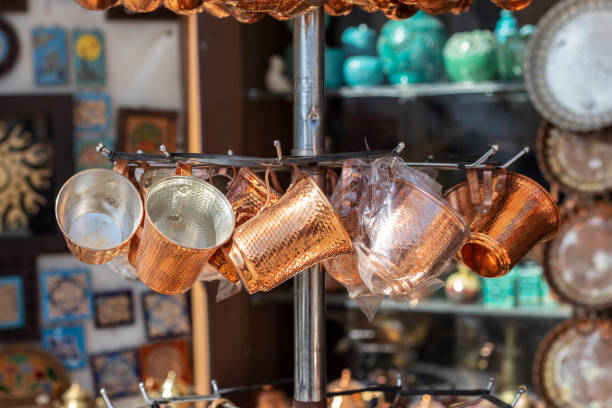 istock Bench with copper utensils in traditional eastern market. Copper tea cups on Eastern Bazaar. 1223674257