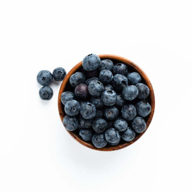 istock Blue berries in a wooden cup. Top View 1223674599