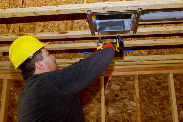 istock Worker installing air conditioner vents in new home construction 1223675971