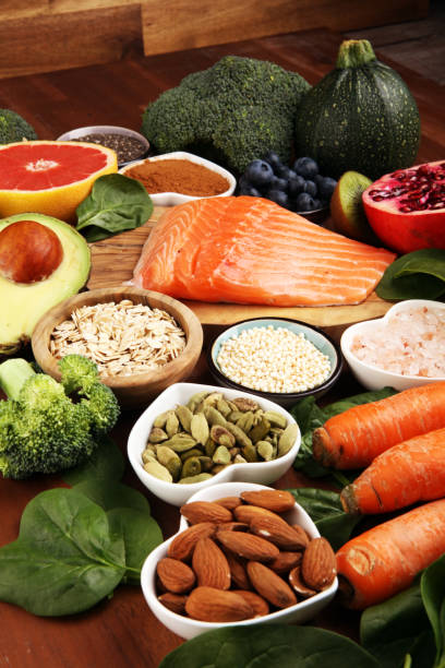 istock Healthy food clean eating selection: fish, fruit, vegetable, cereal, leaf vegetable on rustic background 1223677956