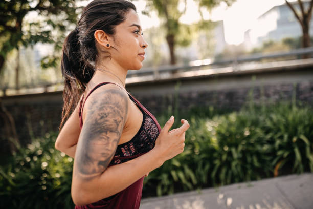 istock Smiling Latin woman jogging in the park 1223677985