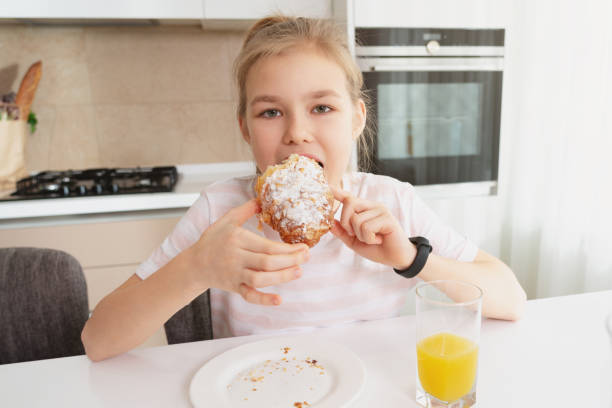 istock Pretty girl eating breakfast in the kitchen alone 1223678222