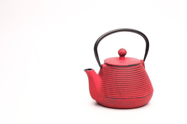 istock Red metal cast-iron traditional teapot on white background. 1223678379