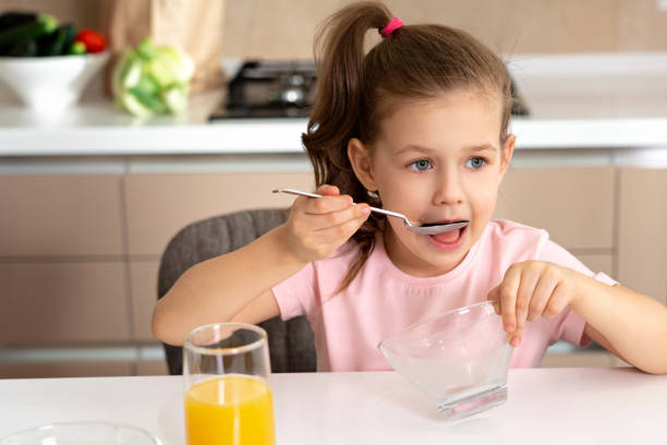 istock Pretty girl eating breakfast in the kitchen alone 1223678425
