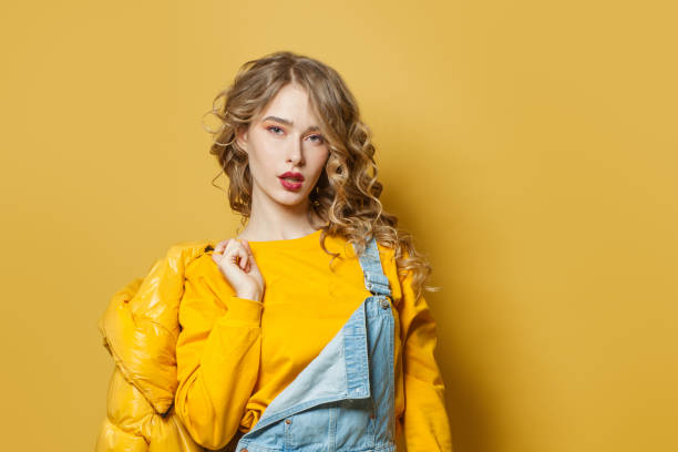 istock Young woman on bright yellow background 1223679389