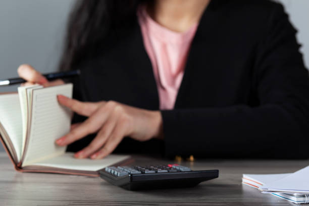 istock woman hand pen with notepad 1223679772