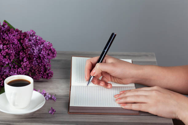istock woman hand pen with notepad 1223679791