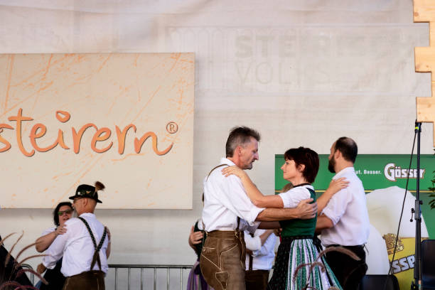 Folk dances of Styrian men and women in bright traditional dresses. Graz/Austria - September 2019: annual autumn festival of Styrian folk culture (Aufsteirern). Folk dances of Styrian men and women in bright traditional dresses. dirndl traditional clothing austria traditional culture stock pictures, royalty-free photos & images