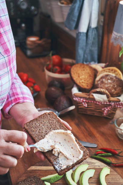 istock Preparing Avocado Sandwich with Brown Bread, Cottage Cheese and Chili 1223681099