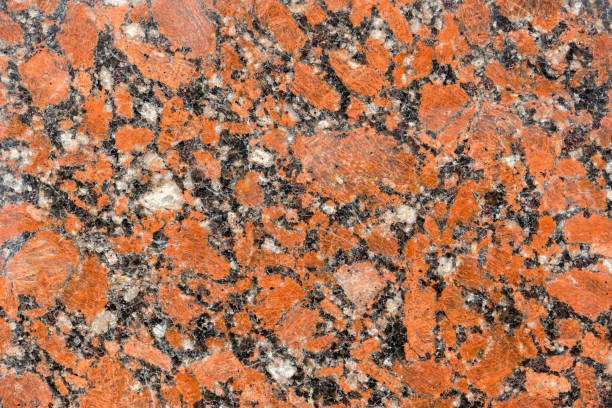 istock natural drawing of granitic surface with rich red hue, coarse-grained structure with small inclusions of various shades. Polished granite tile 1223682677