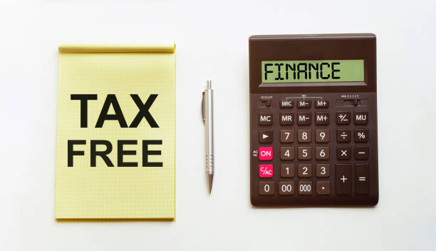 istock Office table with pen, calculator and empty paper with TAX FREE text 1223684933