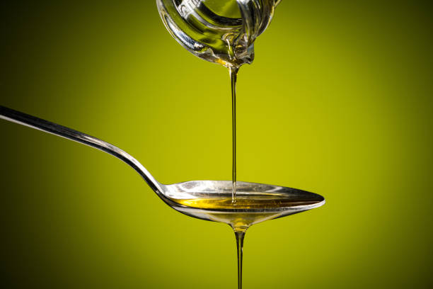 istock olive oil  butler flowing to the spoon 1223687404