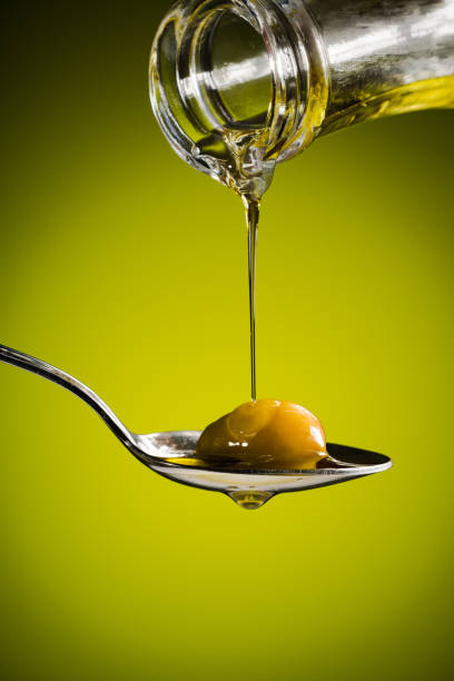 istock Olive oil and green olive on spoon 1223687435