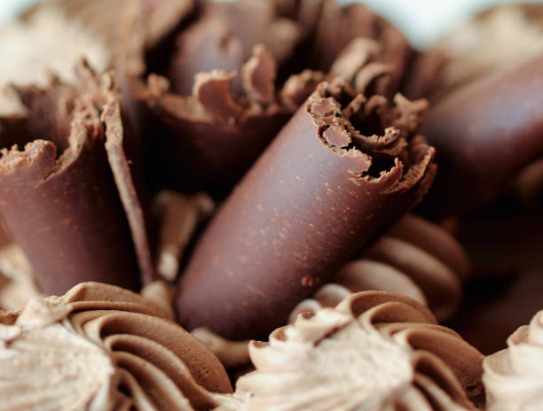 istock Black chocolate cream cake close up background 1223690939