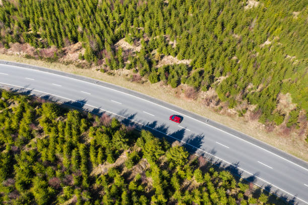 istock red street car from above in an spring forest 1223692016