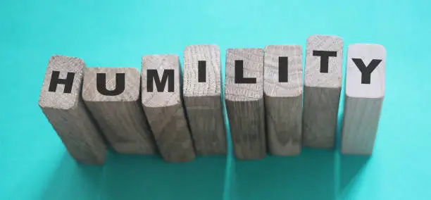HUMILITY word made with letters on wooden building blocks.
