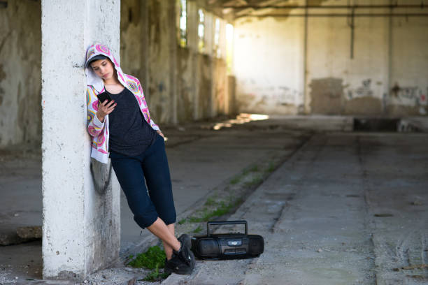 Hip hop female dancer in abandoned building on a sunny day.
