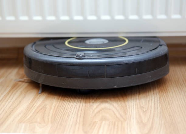 istock robotic vacuum cleaner stuck between floor and radiator 1223697062