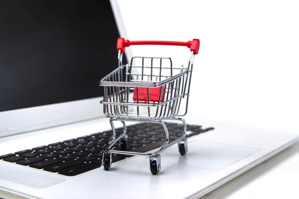 shopping cart on a laptop stock photo