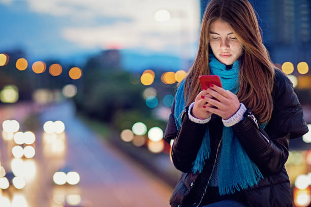 istock Young girl is texting on the bridge at night 1223700867