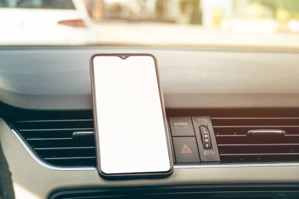 istock smart cell phone in the center car console with white blank screen 1223704021